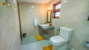 Villa Noble Horizon Sri Lanka interior – bathroom with sink, mirror, toilet and window with natural light