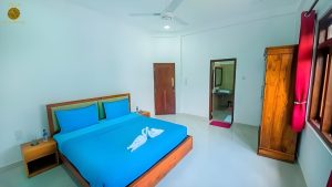 Villa Noble Horizon Sri Lanka interior – double guestroom with king-size bed, wooden furniture and private bathroom access