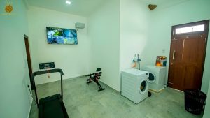 Villa Noble Horizon Sri Lanka interior – laundry area with washing machine, storage and access door