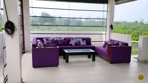 Villa Noble Horizon Sri Lanka – rooftop lounge with purple corner sofa and panoramic view over tropical greenery
